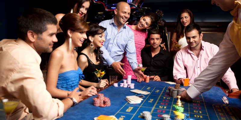 happy friends playing roulette in a casino