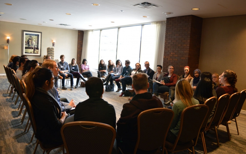 Students break out into a smaller discussion group following a presentation in Calgary.